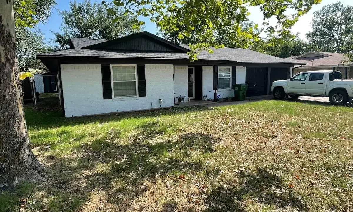 Professional roofing crew working on a residential roof in Tipton